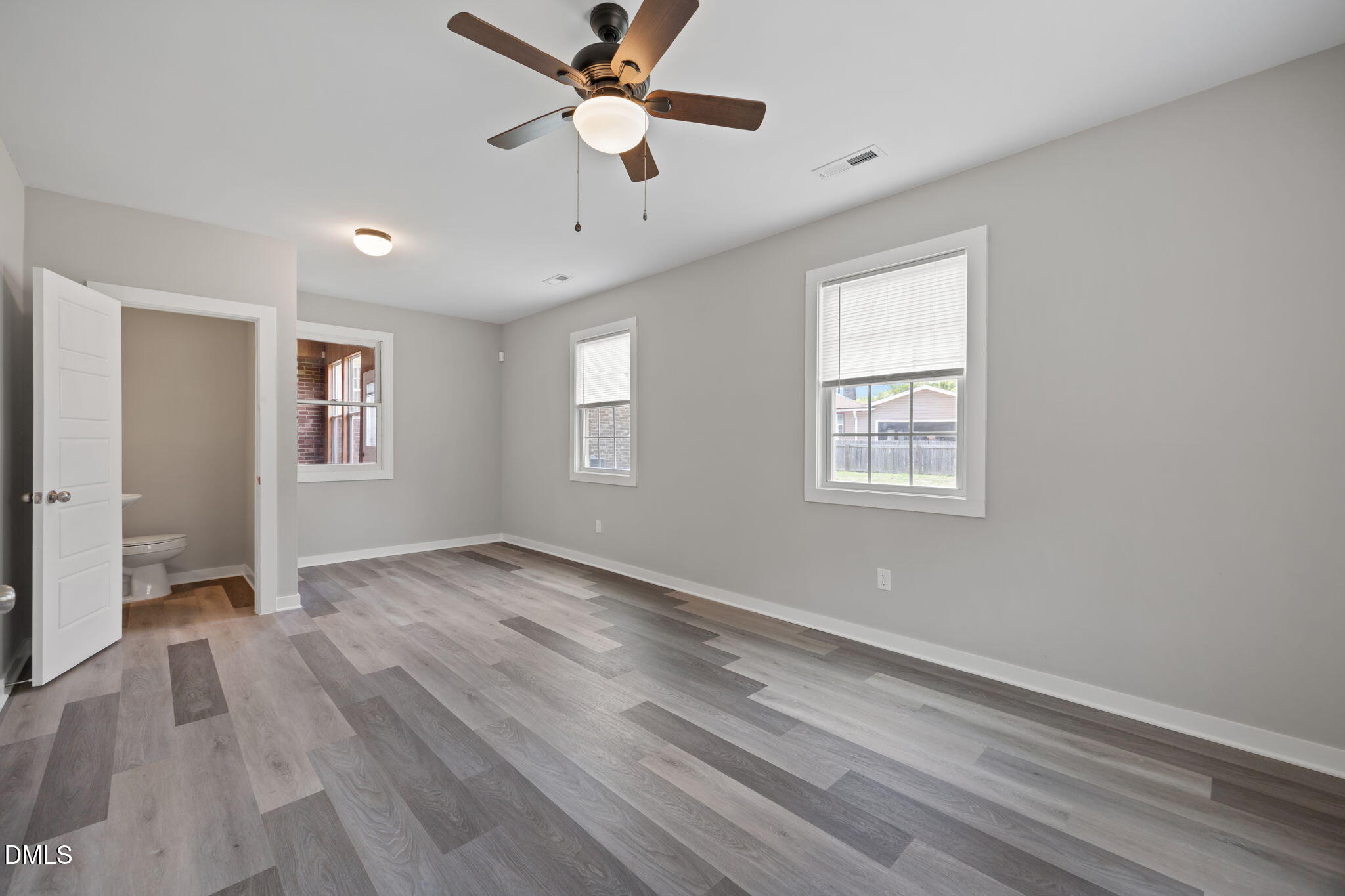 309 Rippling Stream Road Durham, NC 27704 - Photo 26 of 45 a view of an empty room with a window and wooden floor