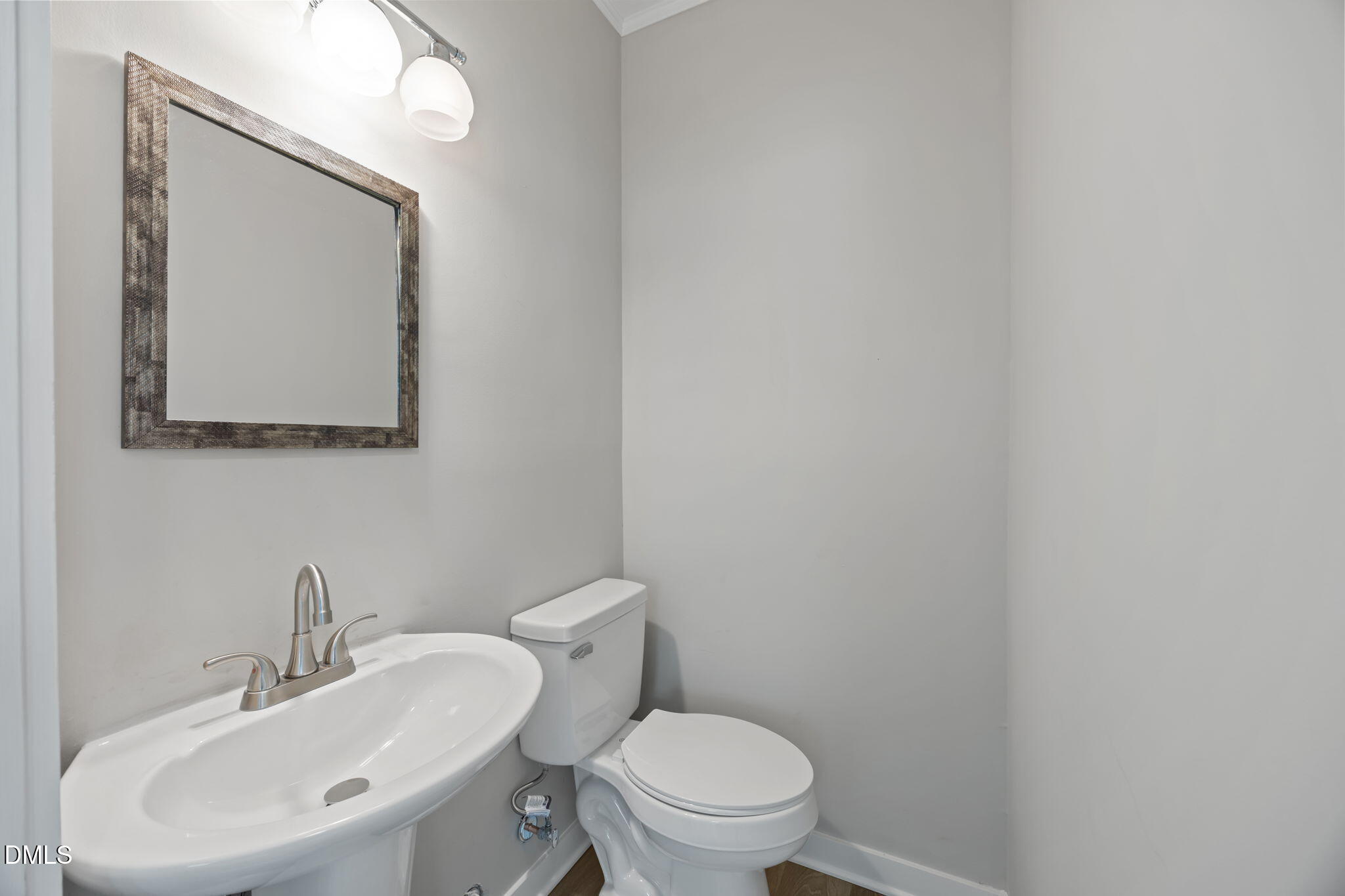 309 Rippling Stream Road Durham, NC 27704 - Photo 27 of 45 a bathroom with a toilet a sink and mirror