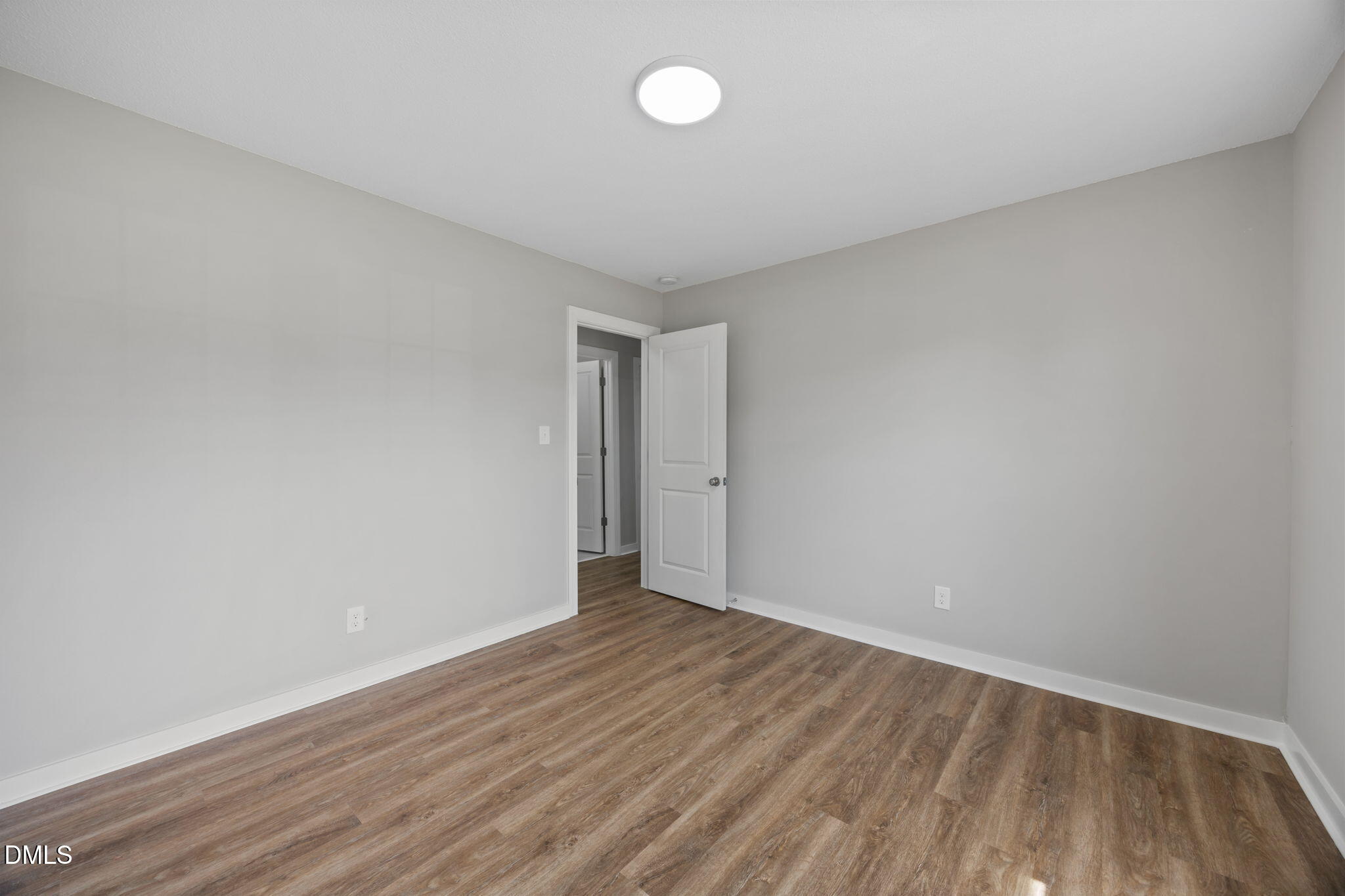 309 Rippling Stream Road Durham, NC 27704 - Photo 29 of 45 a view of an empty room with wooden floor