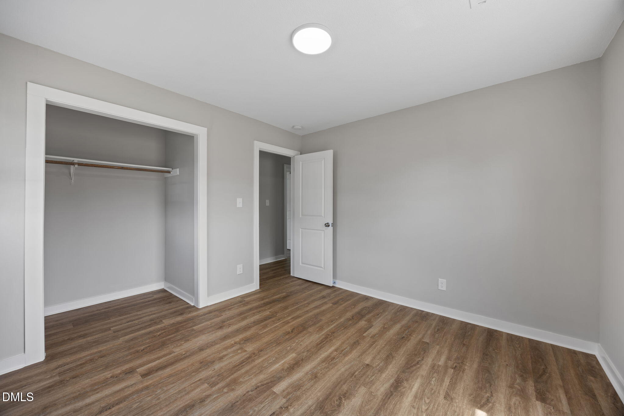 309 Rippling Stream Road Durham, NC 27704 - Photo 33 of 45 a view of an empty room with wooden floor and closet