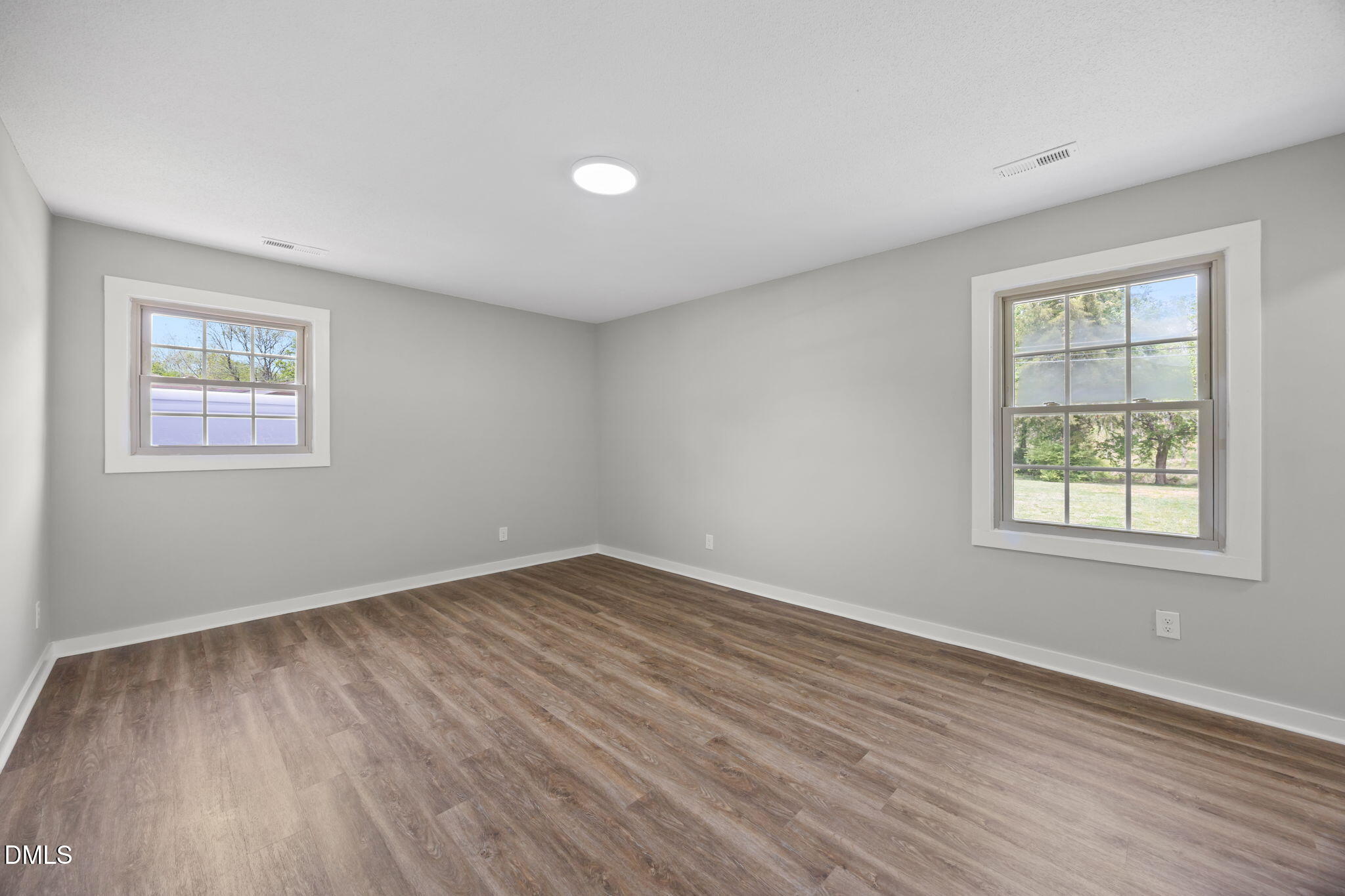 309 Rippling Stream Road Durham, NC 27704 - Photo 34 of 45 a view of an empty room with wooden floor and a window