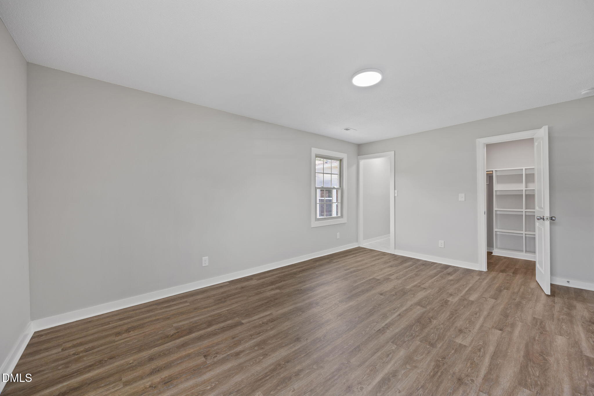 309 Rippling Stream Road Durham, NC 27704 - Photo 37 of 45 a view of an empty room with wooden floor and a window