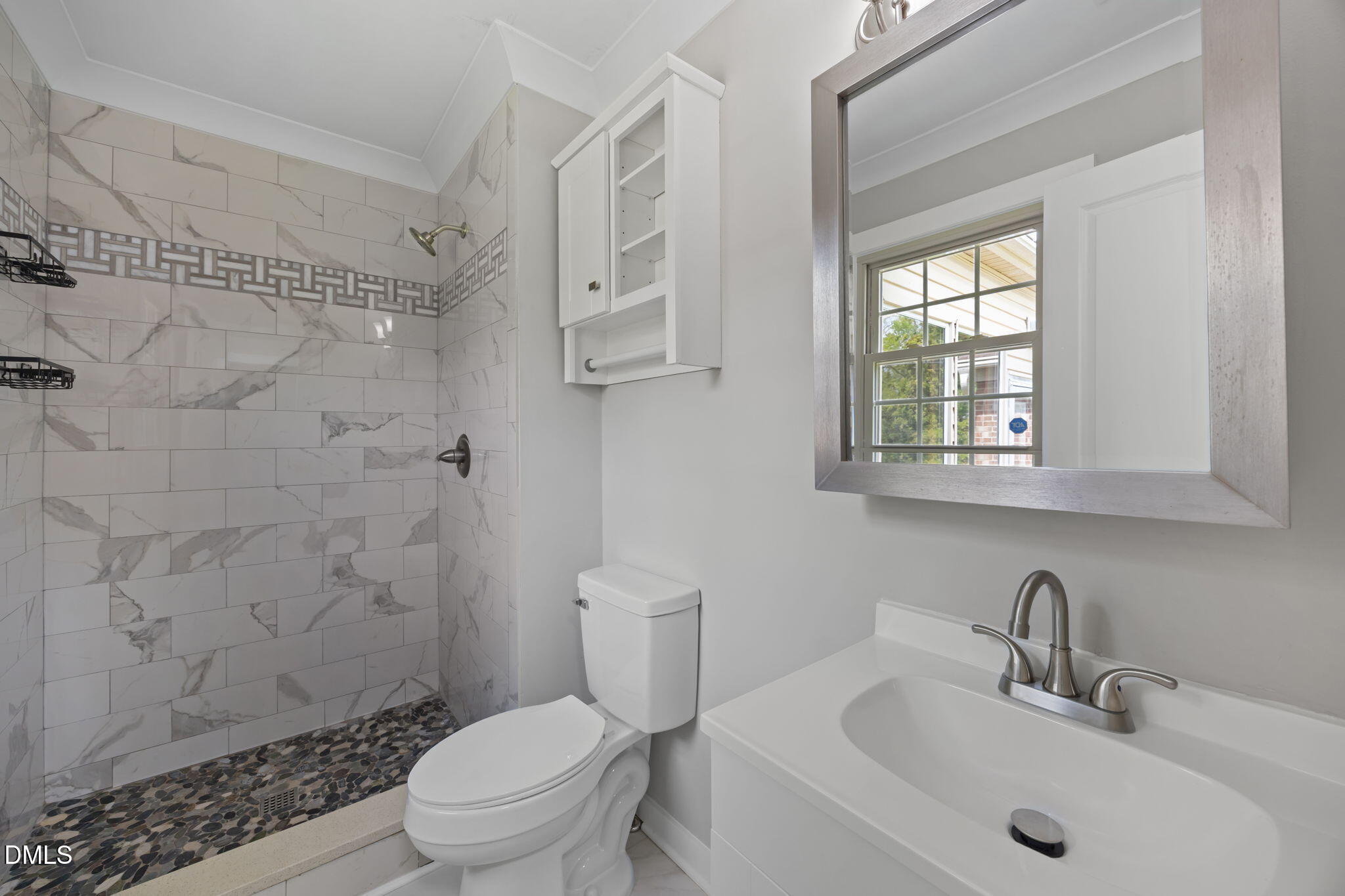 309 Rippling Stream Road Durham, NC 27704 - Photo 38 of 45 a bathroom with a sink toilet and shower
