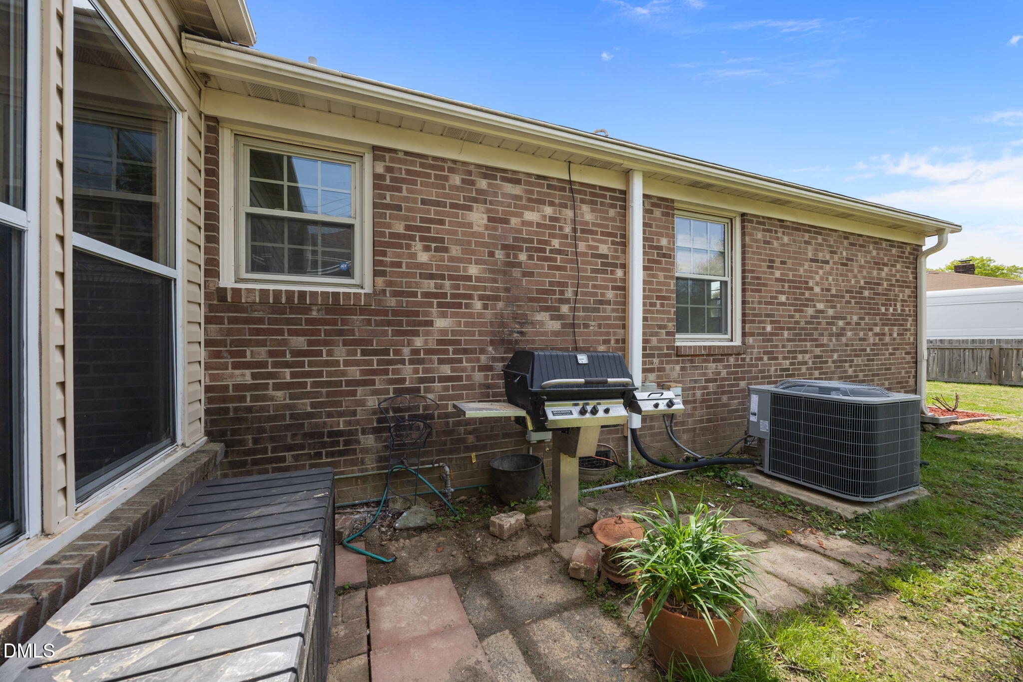 309 Rippling Stream Road Durham, NC 27704 - Photo 45 of 45 a brick house with a bench in front of it