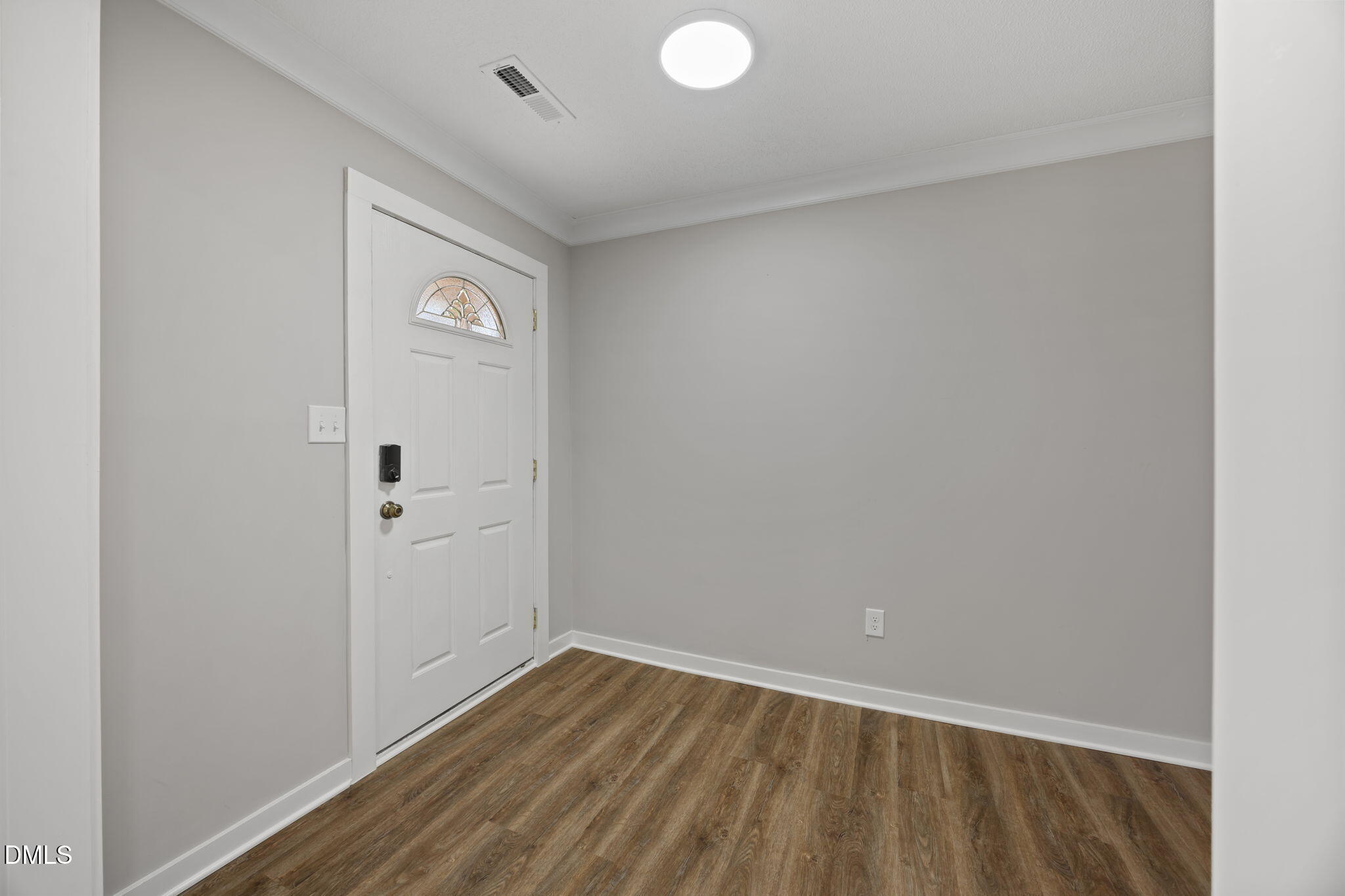 309 Rippling Stream Road Durham, NC 27704 - Photo 9 of 45 a view of an empty room with wooden floor and closet