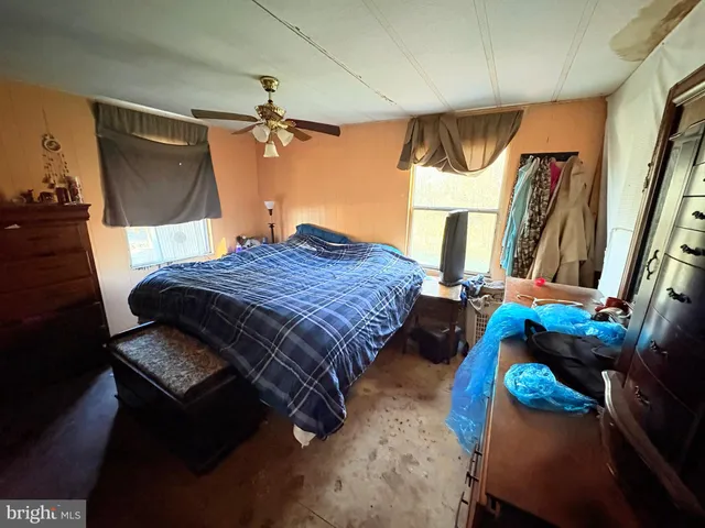 a bedroom with bed and a mirror