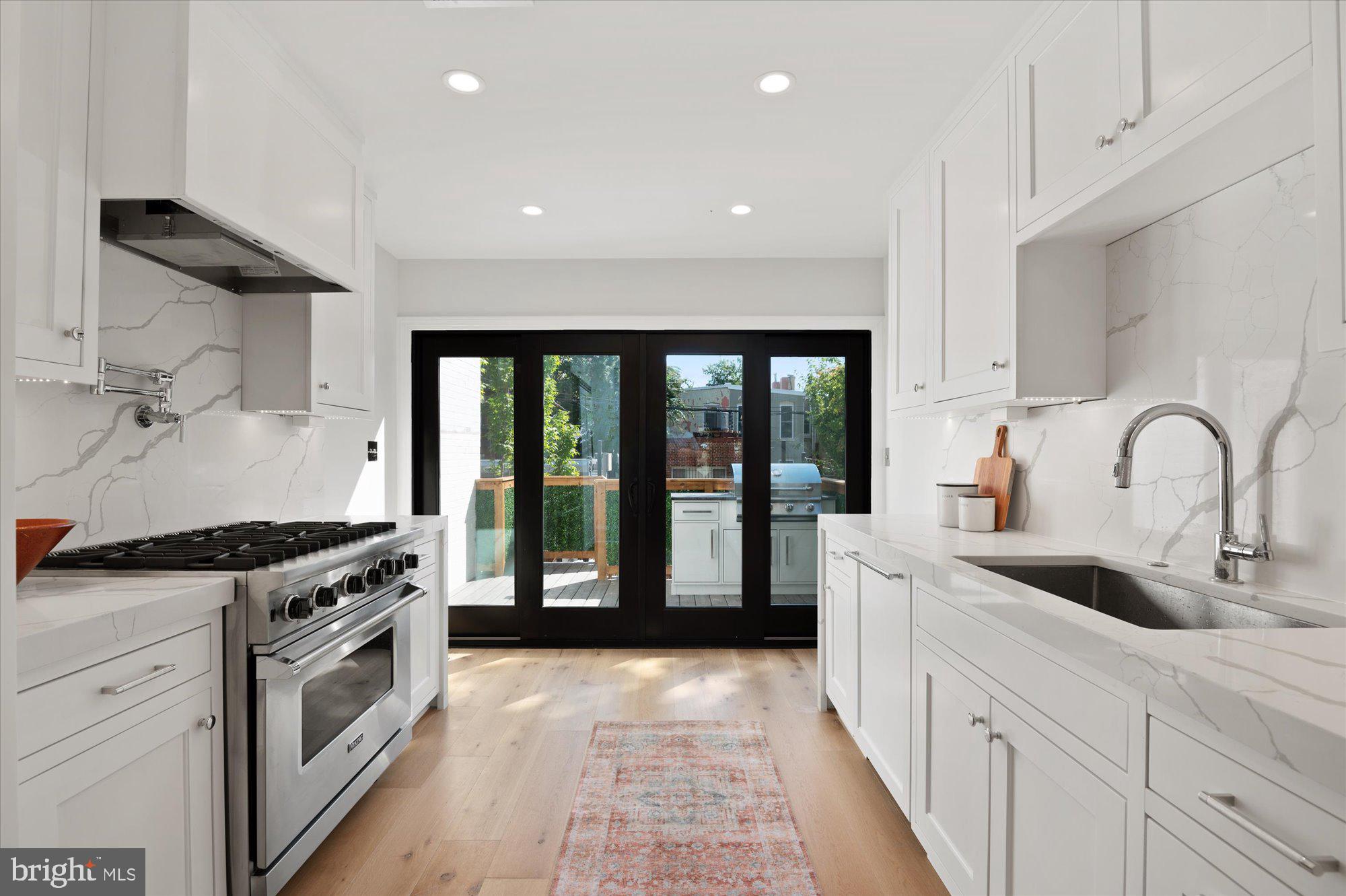 1831 12th Street Northwest Washington, DC 20009 - Photo 15 of 47 a kitchen with granite countertop a stove and a sink