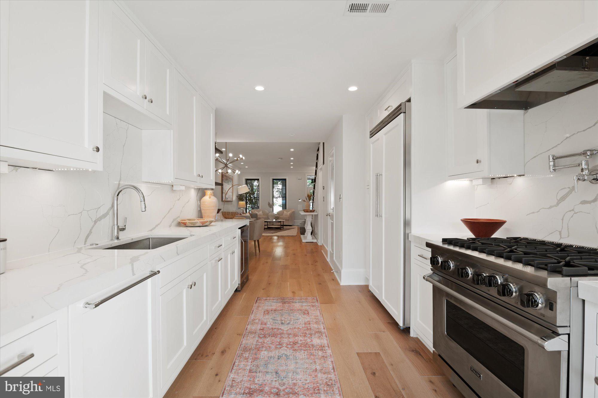 1831 12th Street Northwest Washington, DC 20009 - Photo 16 of 47 a kitchen with granite countertop a sink stove and cabinets