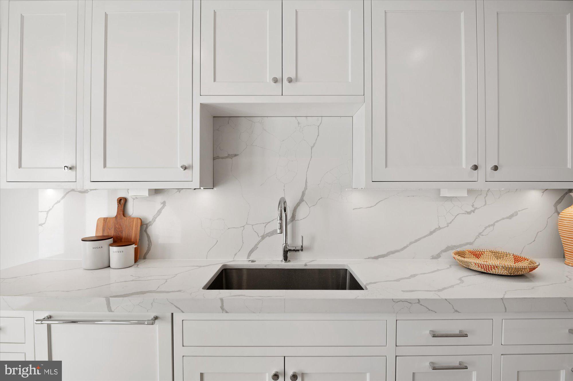 1831 12th Street Northwest Washington, DC 20009 - Photo 18 of 47 a kitchen with white cabinets and a sink
