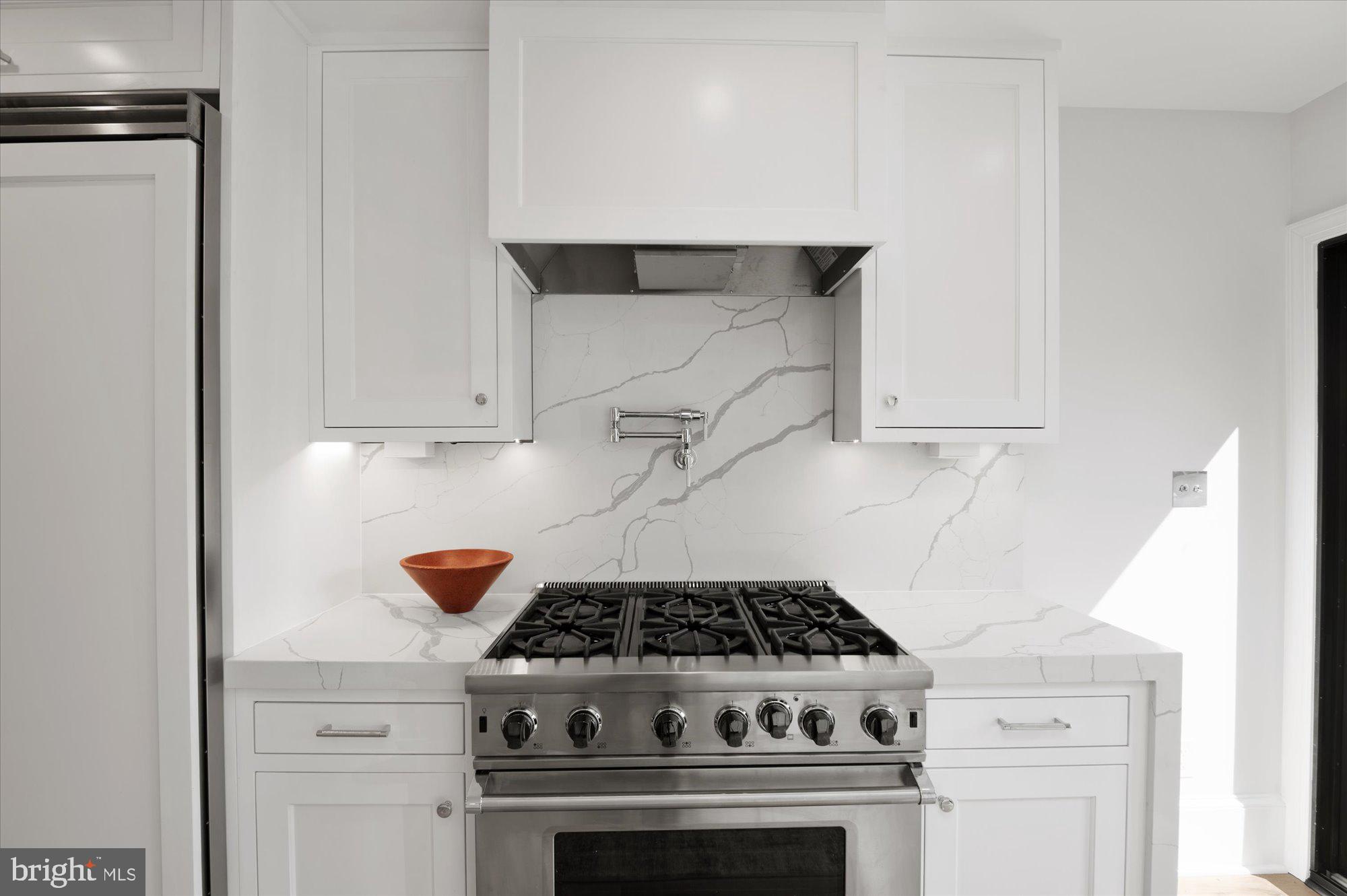1831 12th Street Northwest Washington, DC 20009 - Photo 19 of 47 a stove top oven sitting inside of a kitchen
