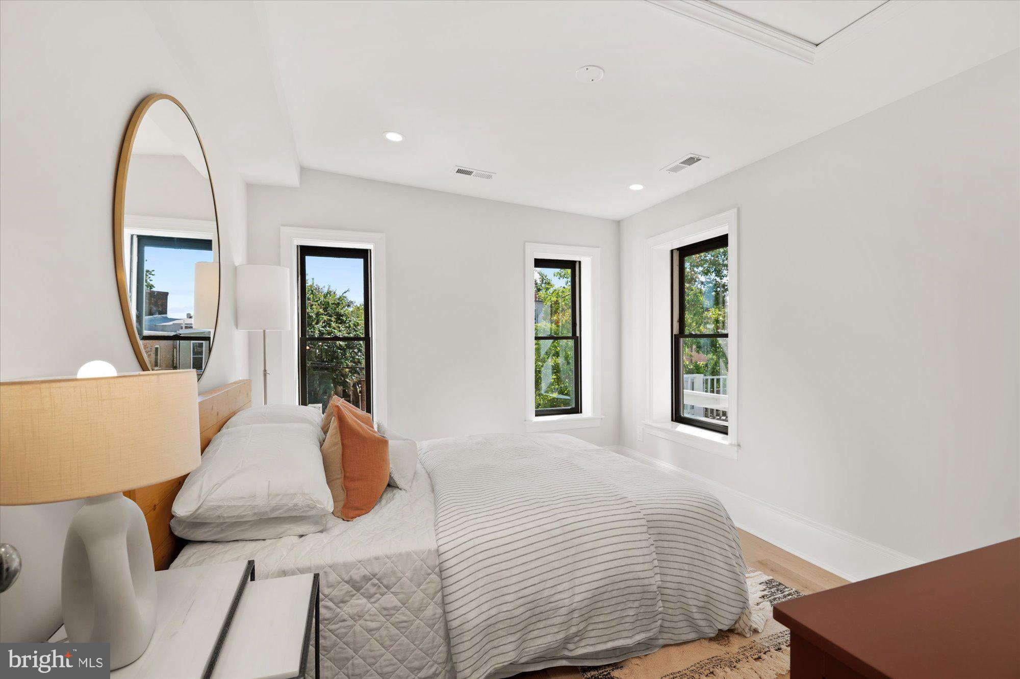 1831 12th Street Northwest Washington, DC 20009 - Photo 29 of 47 a bedroom with a large bed and two windows