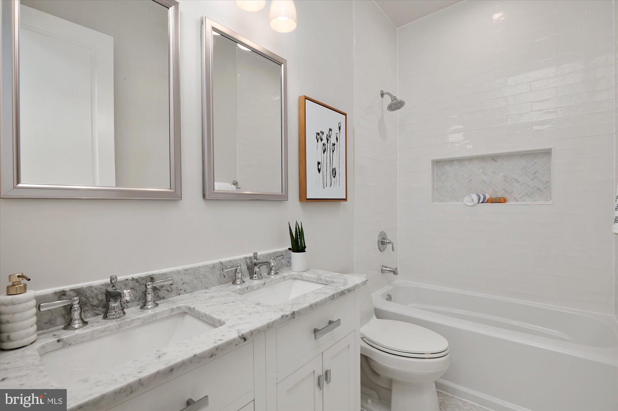 1831 12th Street Northwest Washington, DC 20009 - Photo 32 of 47 a bathroom with a granite countertop sink toilet and a bathtub