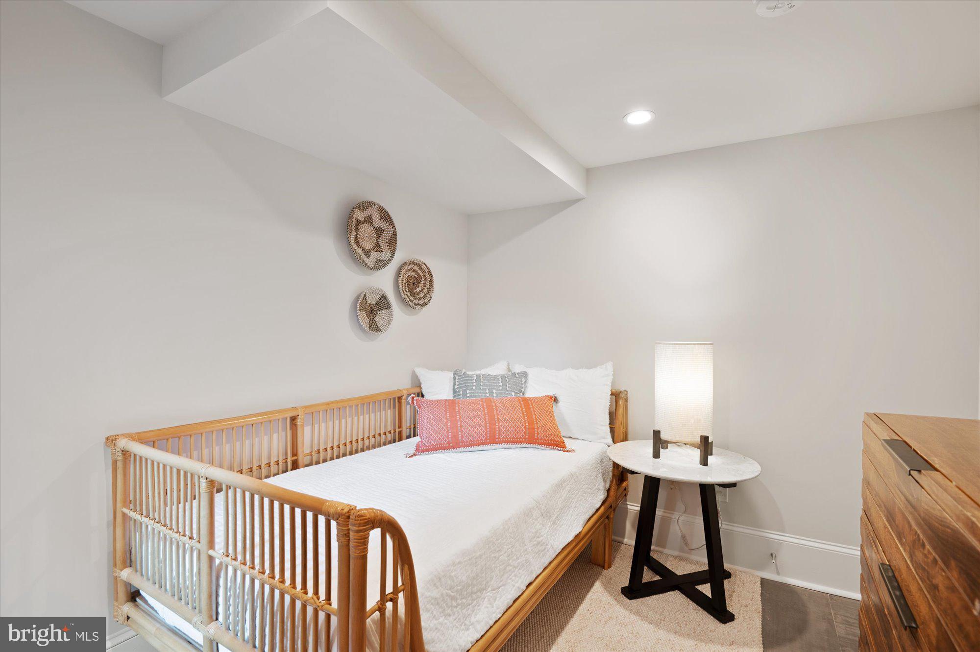 1831 12th Street Northwest Washington, DC 20009 - Photo 38 of 47 a bedroom with a bed and painting on the wall