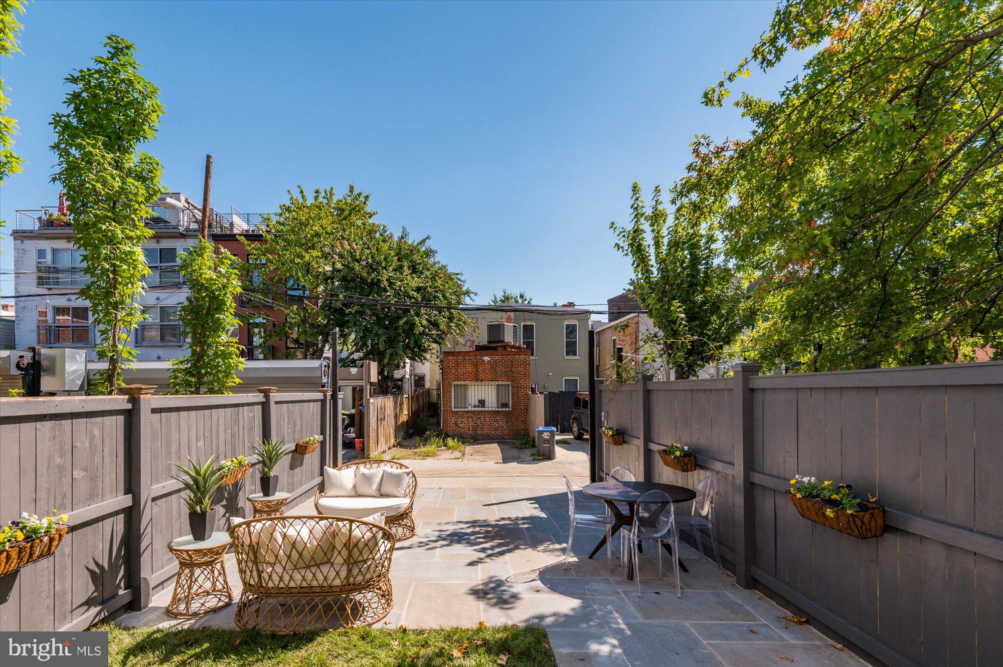 1831 12th Street Northwest Washington, DC 20009 - Photo 41 of 47 a view of a patio with couches and table and chairs and potted plants