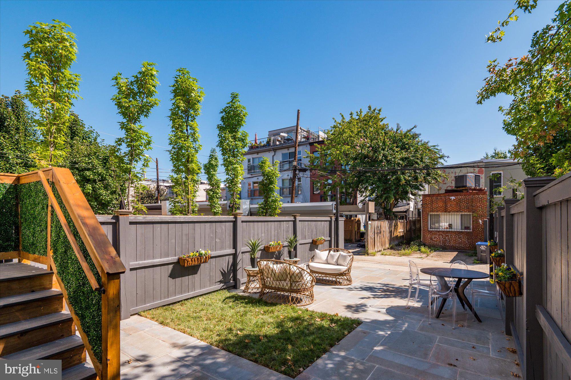 1831 12th Street Northwest Washington, DC 20009 - Photo 42 of 47 a view of a patio with couches table and chairs and potted plants with sky view