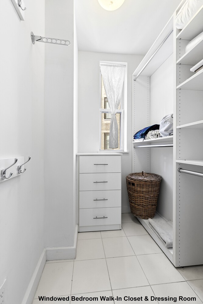 156 East 79th Street, Unit 9F Manhattan, NY 10075 - Photo 10 of 12 a bathroom with a vanity and a shower