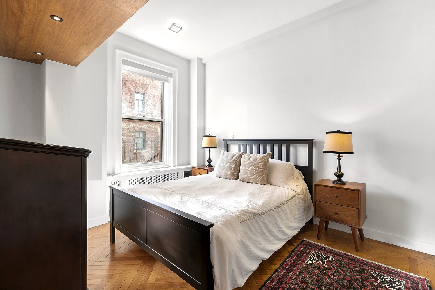 156 East 79th Street, Unit 9F Manhattan, NY 10075 - Photo 8 of 12 a bedroom with a bed and a table