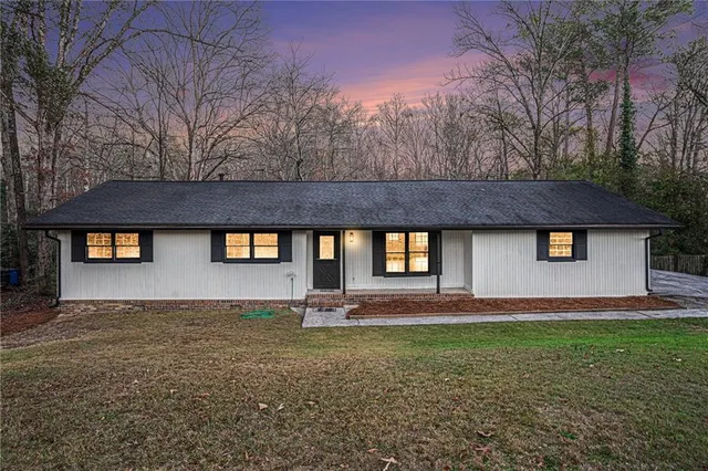 a front view of house with yard and trees