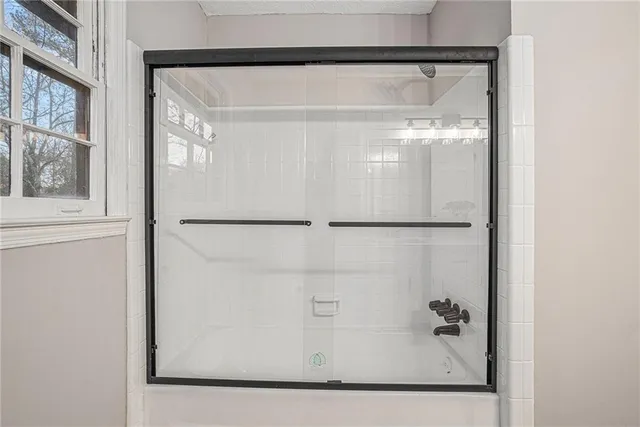 a bathroom with a glass shower door