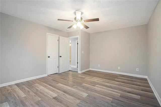 a view of an empty room with wooden floor