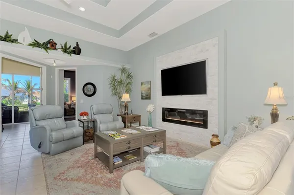 a living room with furniture a fireplace and a flat screen tv