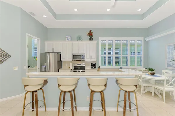 a kitchen with white cabinets and white appliances