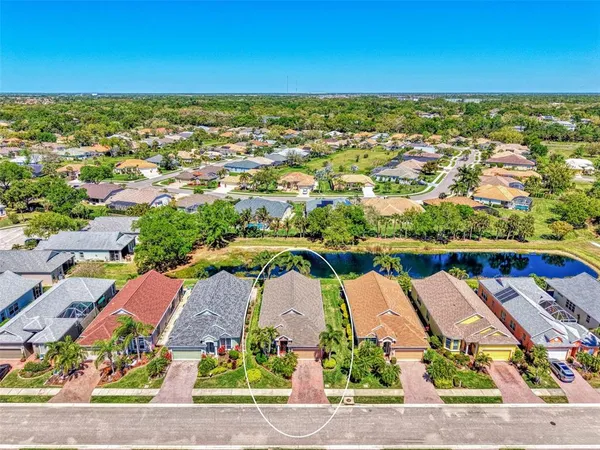 an aerial view of residential houses with outdoor space and swimming pool