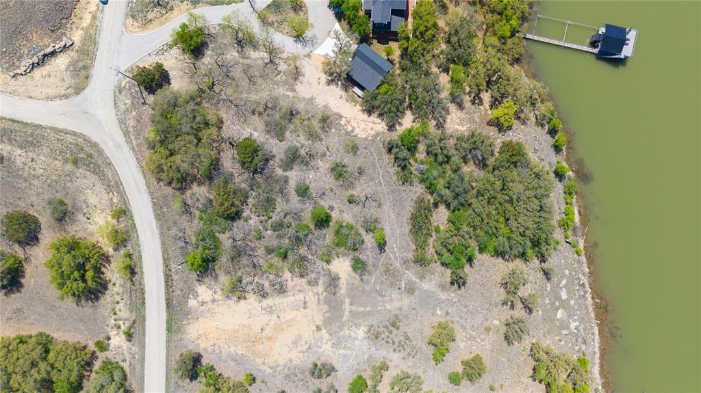 Lot 23 Turner Ranch Road Brownwood, TX 76801 - Photo 13 of 13 Waterfront land with natural vegetation and a paved roadway