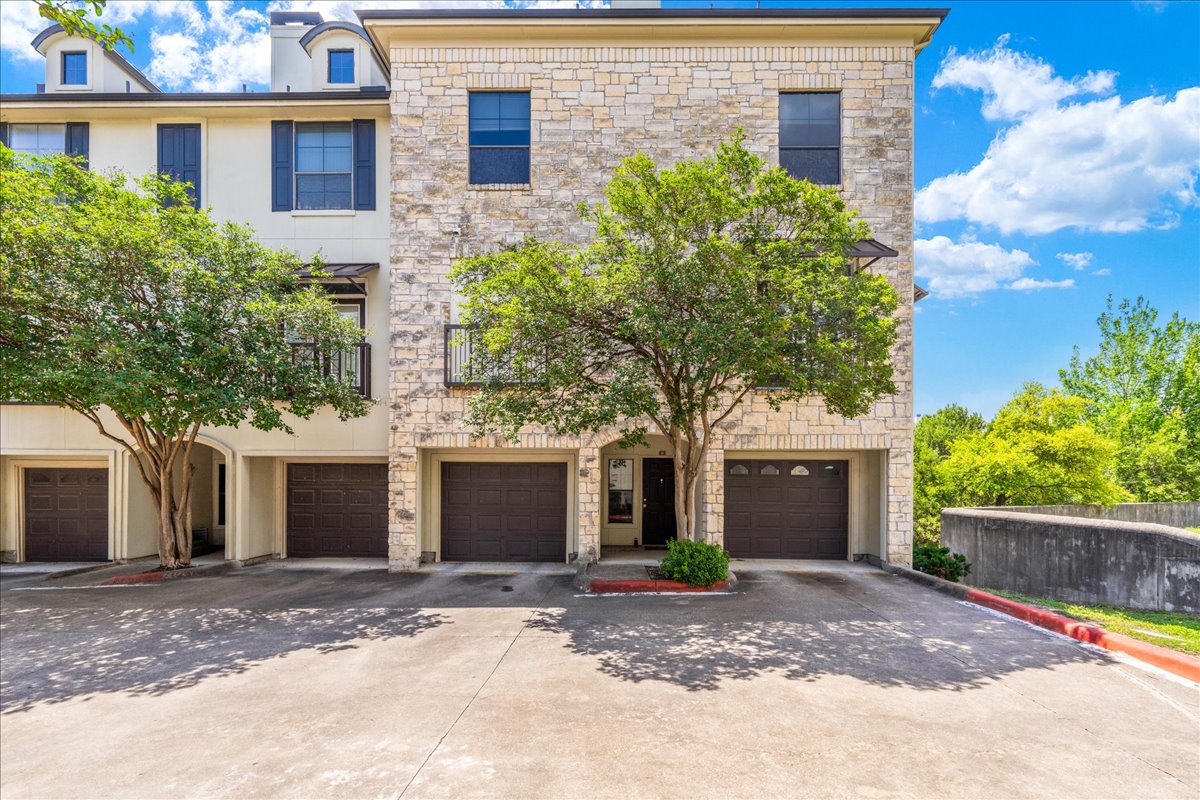 7701 Rialto Boulevard, Unit 91 Austin, TX 78735 - Photo 31 of 39 a view of a house with a yard and plants