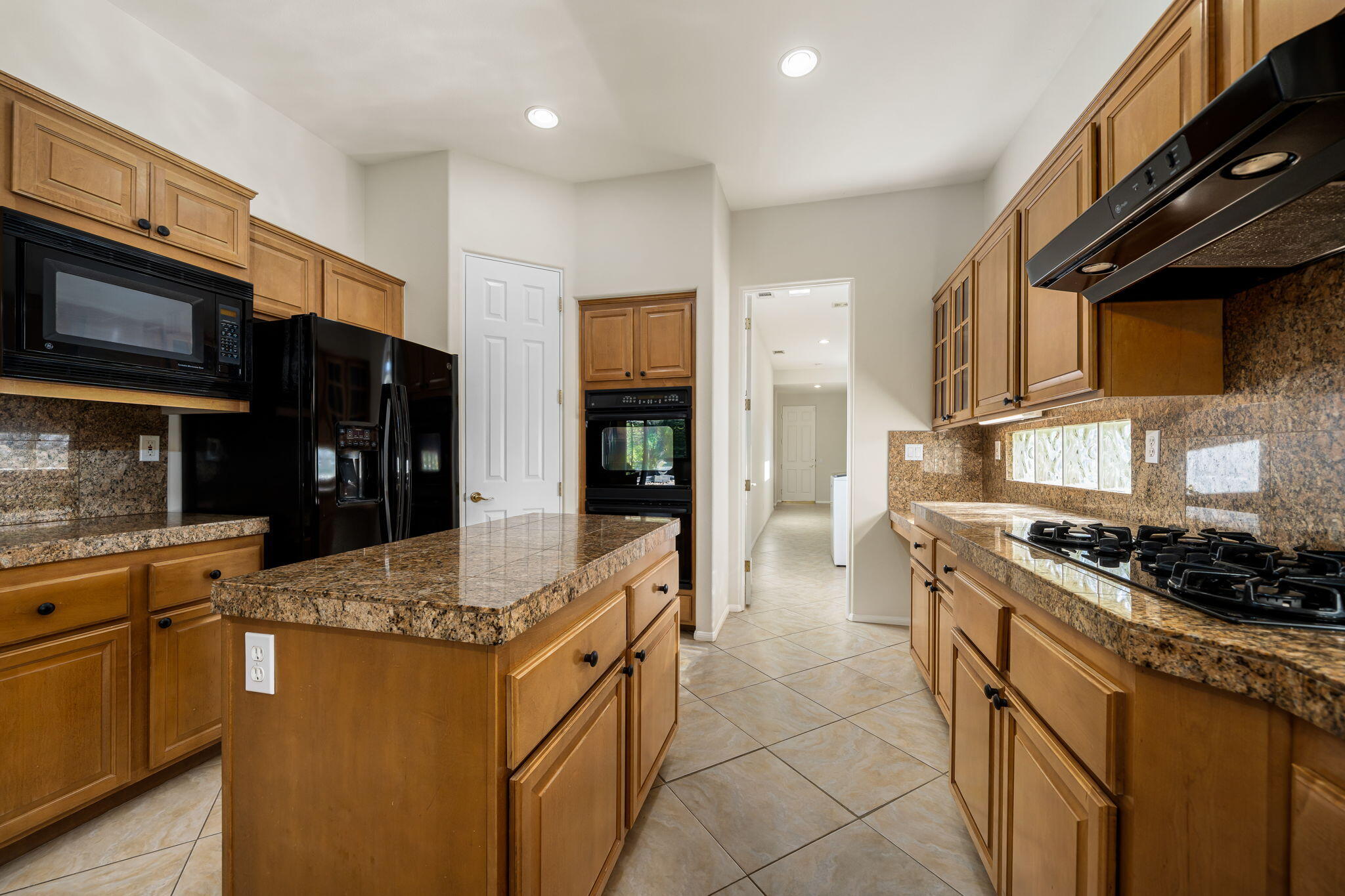 54275 Riviera La Quinta, CA 92253 - Photo 24 of 50 a kitchen with stainless steel appliances granite countertop a stove sink and cabinets