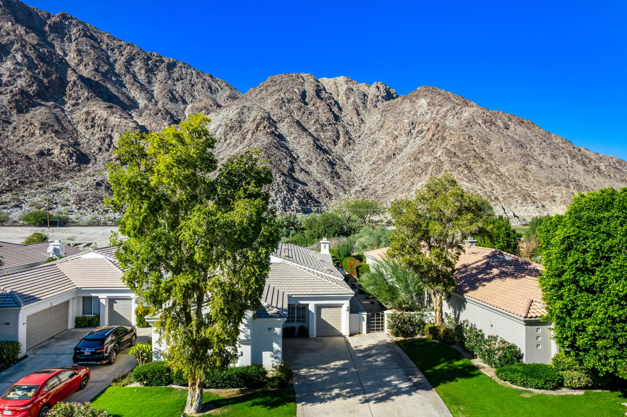 54275 Riviera La Quinta, CA 92253 - Photo 41 of 50 a view of a house with a yard and potted plants