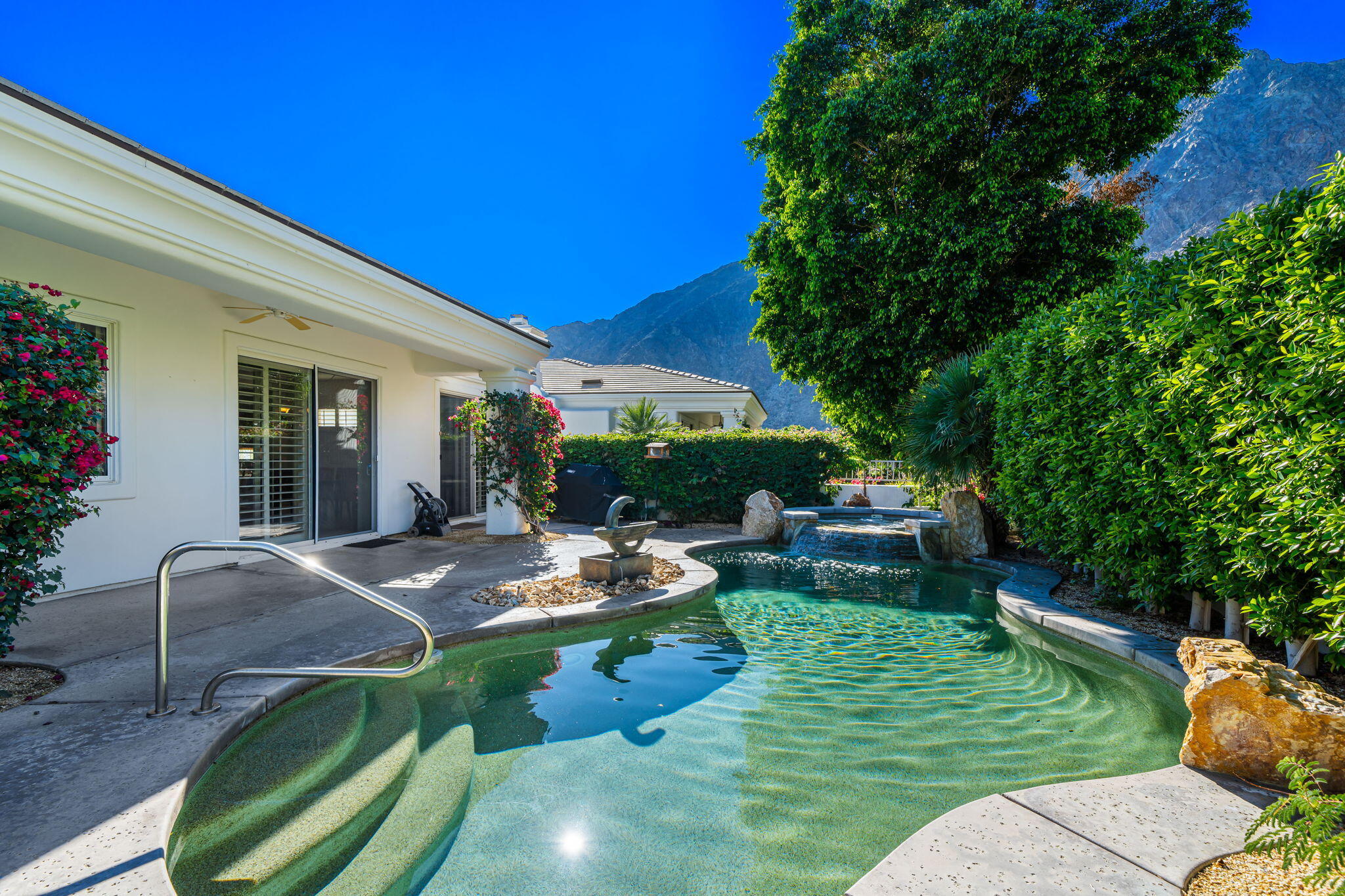 54275 Riviera La Quinta, CA 92253 - Photo 46 of 50 a view of backyard of house with seating area