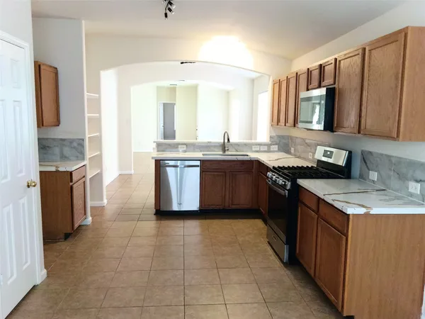 a kitchen with a sink stove and cabinets