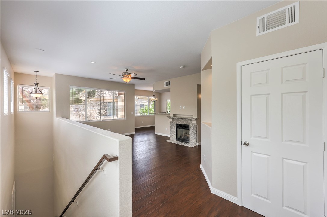 9050 West Warm Springs Road, Unit 2033 Las Vegas, NV 89148 - Photo 4 of 30 Rich hardwood flooring leads into an inviting living area with a beautiful fireplace.