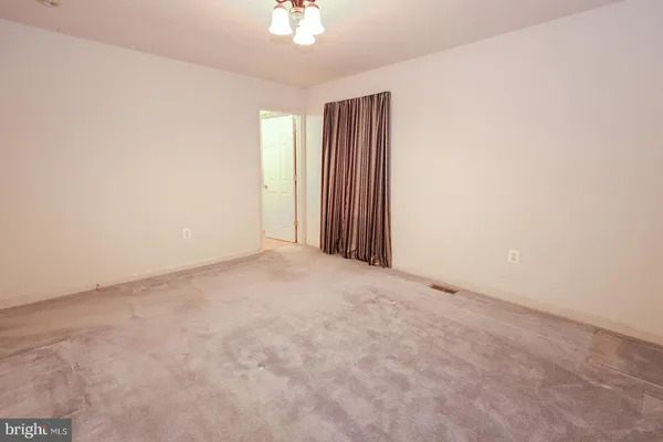 a room with pool table and windows