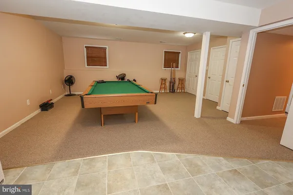 a roof deck with table and chairs and wooden floor
