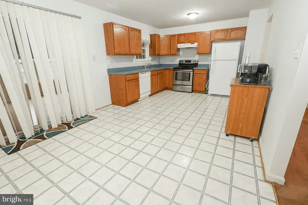 a kitchen with stainless steel appliances granite countertop a stove a sink dishwasher and a refrigerator