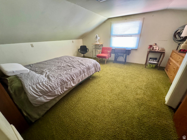178 Walnut Lane Moab, UT 84532 - Photo 19 of 25 Room with textured green carpeting, sloped ceilings, and a window with blinds