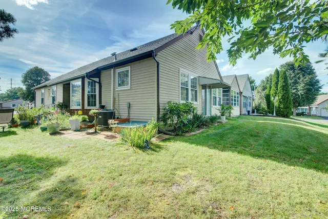 a front view of house with yard and green space