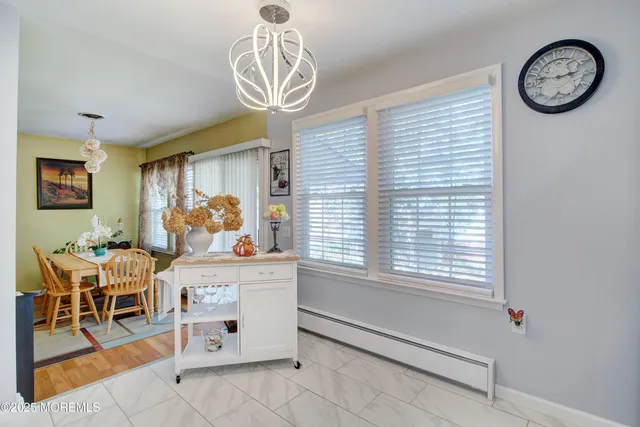 a view of a dining room with furniture and a large window