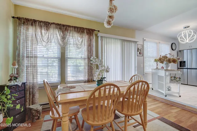 a view of a dining room with furniture and chandelier