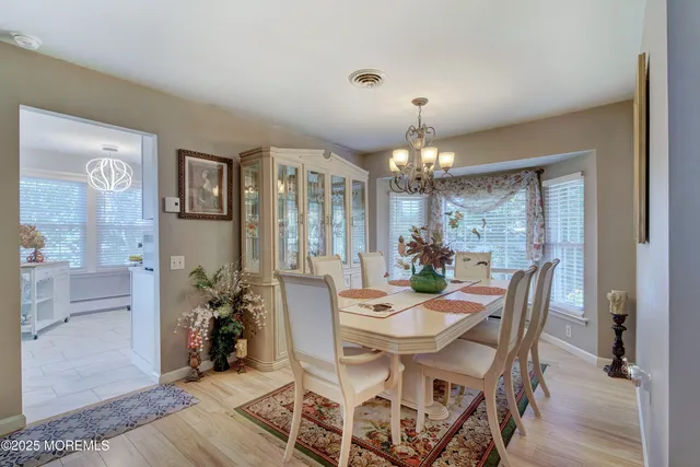 a view of a dining room with furniture and chandelier