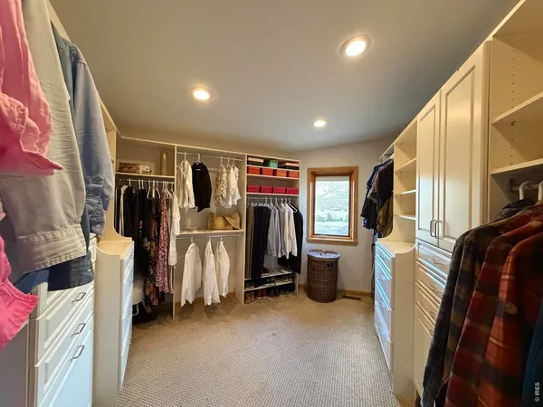 a spacious bedroom with a bed and a large window