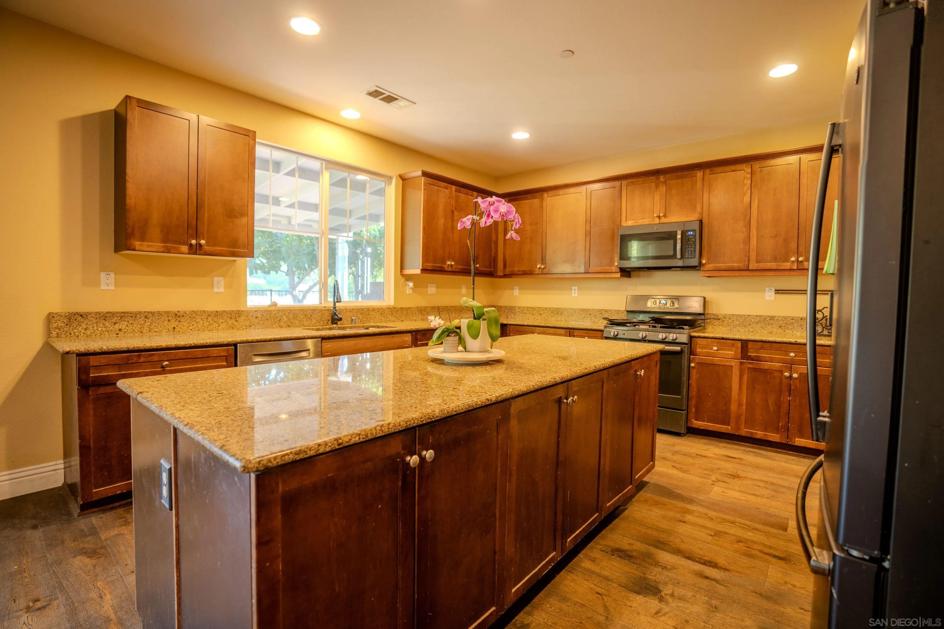 3283 Beven Drive Escondido, CA 92027 - Photo 12 of 64 a kitchen with kitchen island granite countertop a sink counter top space and stainless steel appliances