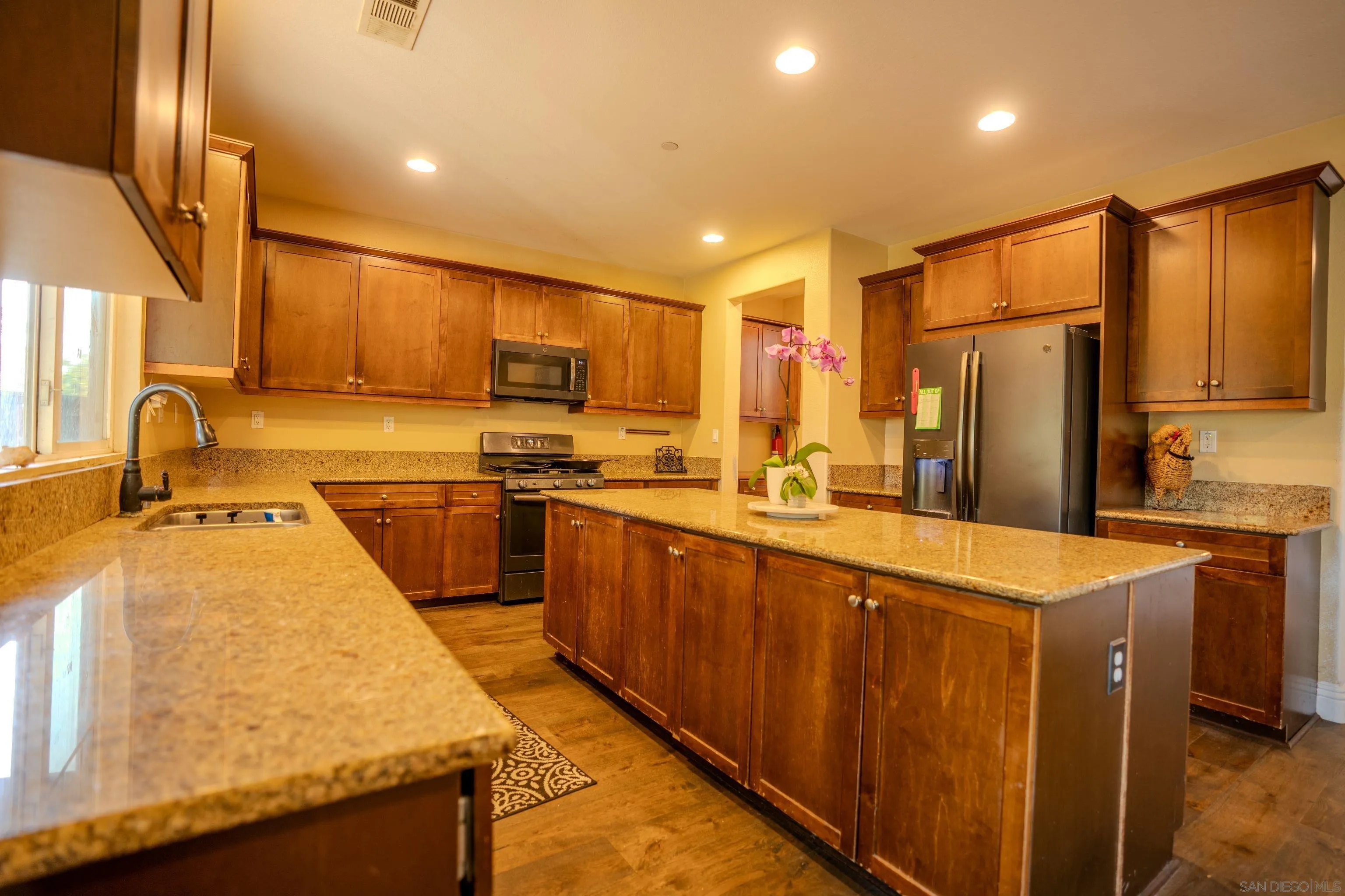3283 Beven Drive Escondido, CA 92027 - Photo 13 of 64 a kitchen with stainless steel appliances granite countertop a sink a stove and a refrigerator