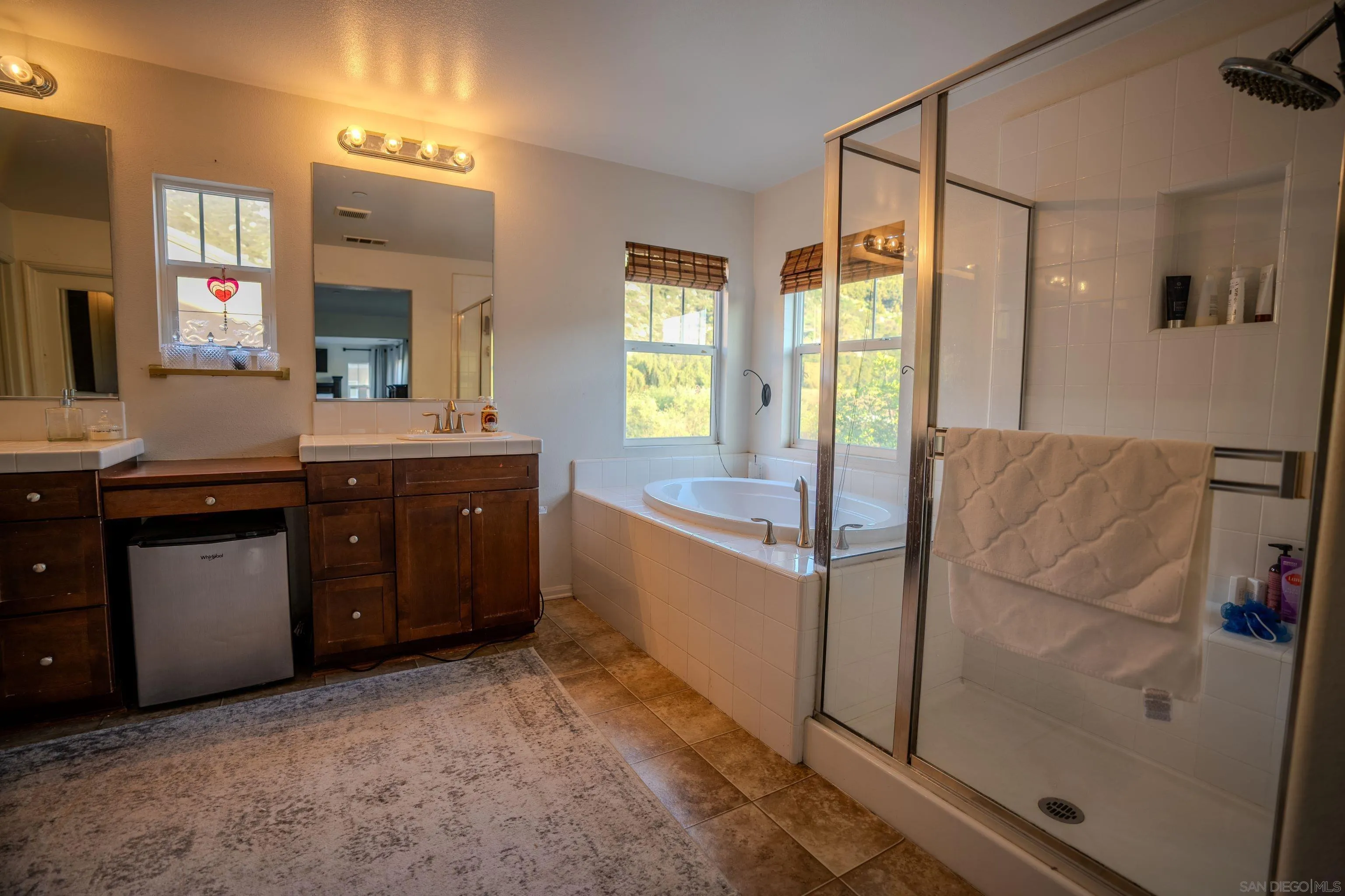 3283 Beven Drive Escondido, CA 92027 - Photo 27 of 64 a spacious bathroom with a tub sink and mirror