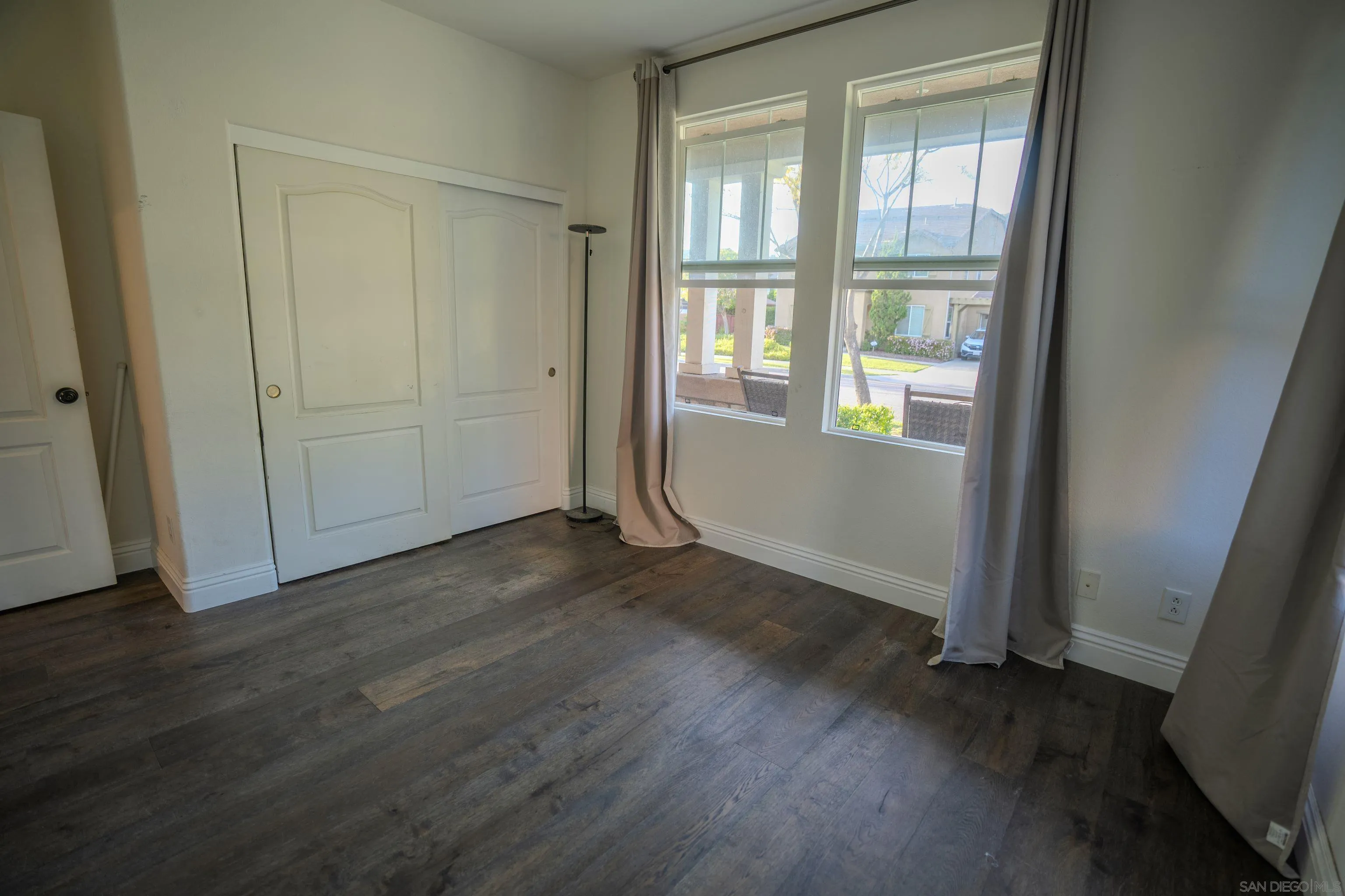 3283 Beven Drive Escondido, CA 92027 - Photo 30 of 64 an empty room with wooden floor and windows