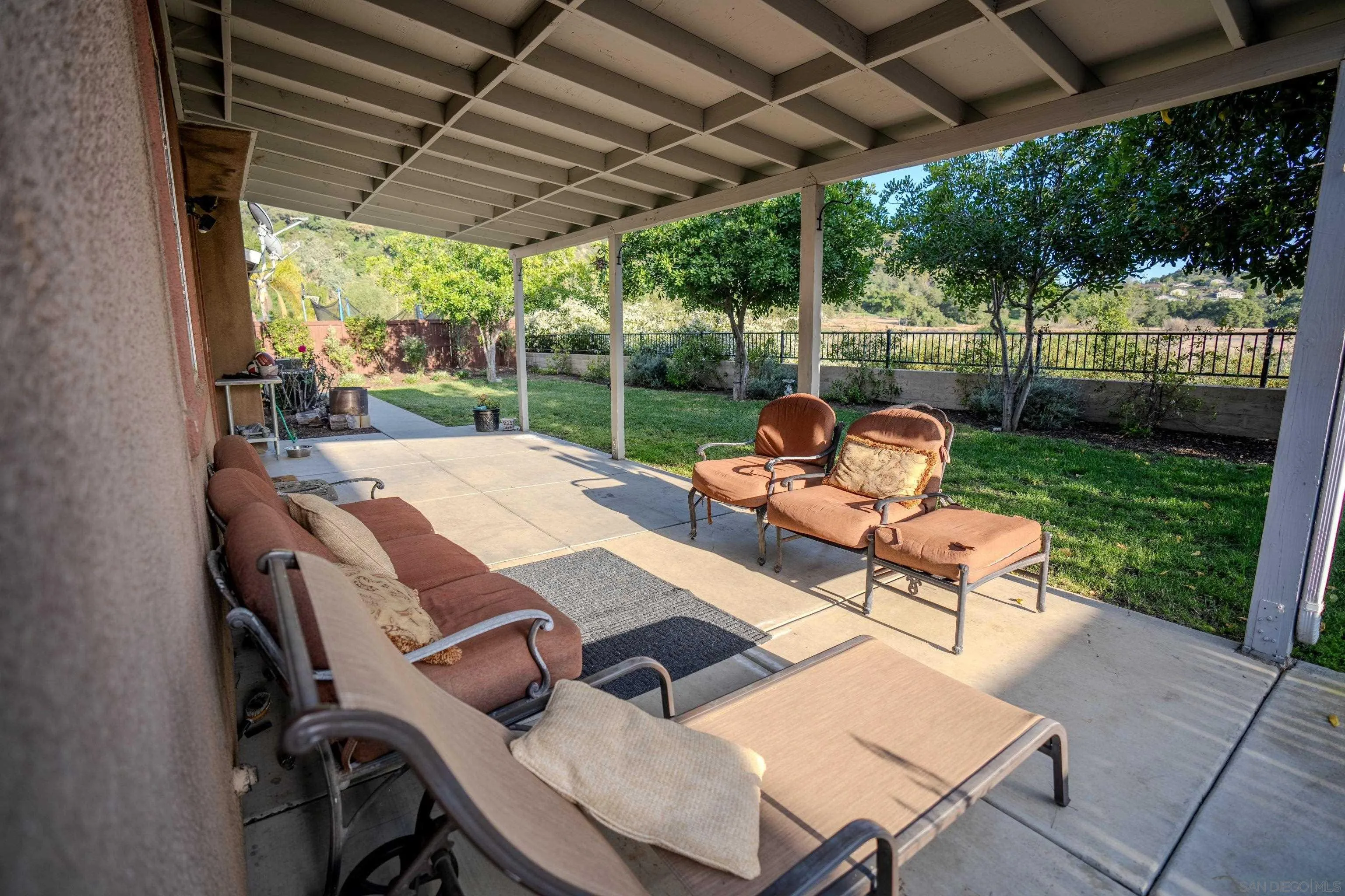 3283 Beven Drive Escondido, CA 92027 - Photo 46 of 64 a view of a patio with a table chairs and a backyard