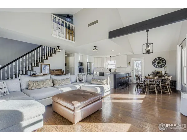 a living room with lots of furniture and a large window