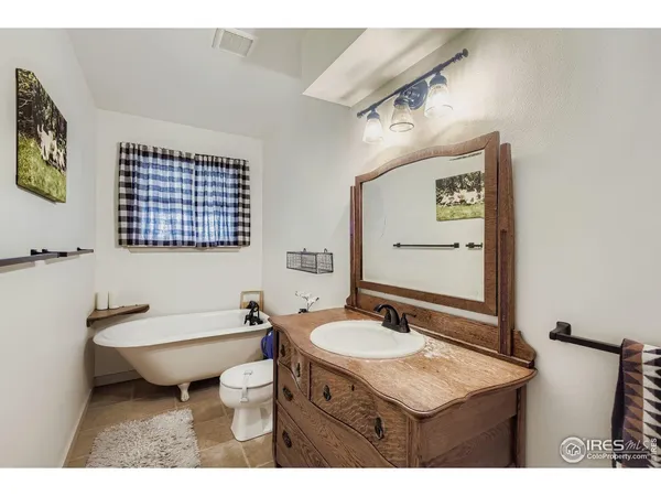 a bathroom with a sink mirror and toilet